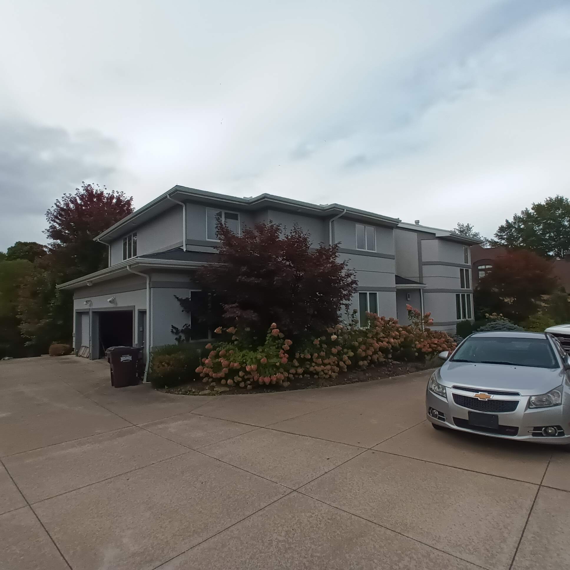 Two-story residential home exterior restored after storm damage